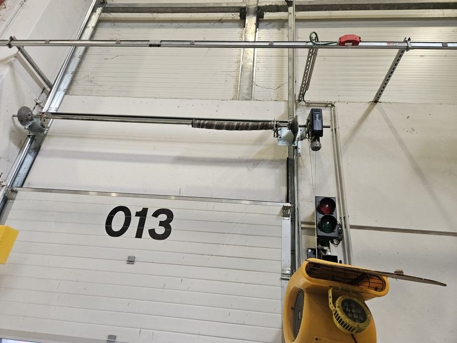 Portone sezionale di un'autorimessa con molla a torsione e motore a soffitto